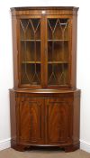 Reproduction mahogany double bow front corner cabinet, projecting cornice, dentil frieze,