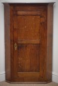 Early 20th century oak wall hanging corner cabinet, projecting cornice,