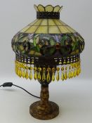 Tiffany style lamp with decorated glass shade and amber glass drops,