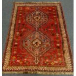 Persian red ground rug, two medallions,
