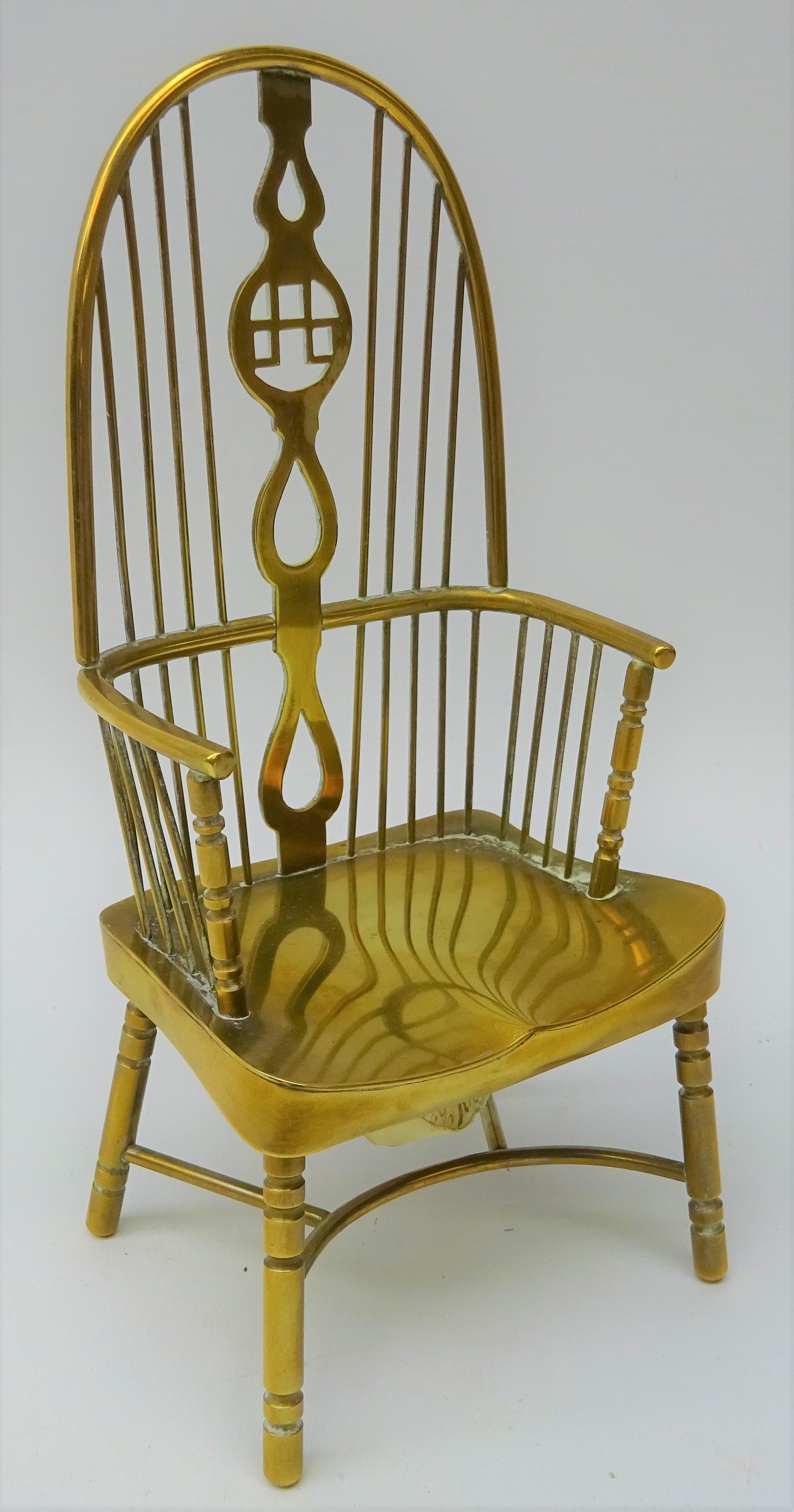 Miniature brass double bow Windsor chair with saddle seat and crinoline stretcher,