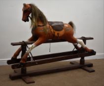 Carved wood and painted rocking horse on trestle base,