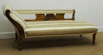 Edwardian walnut framed chaise longue, upholstered in a striped beige fabric,