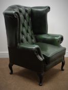 Georgian style wing back armchair upholstered in deep buttoned green leather, on cabriole legs,