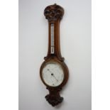 Edwardian carved oak aneroid barometer with thermometer, circular dial signed R.
