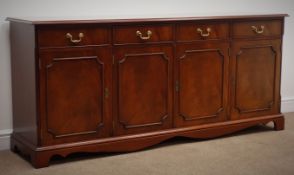 Georgian style cross banded mahogany sideboard, four drawers above four cupboard doors,