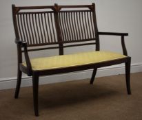 Edwardian inlaid mahogany two seat settee, shaped stick back and upholstered seat,