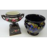 Early 20th century porcelain two handled pedestal urn decorated with roses on black ground H28cm
