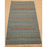 Kilim blue ground rug, red and beige striped field,