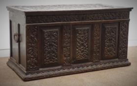 18th century and later oak coffer with three panelled front, all over carved with strap work,