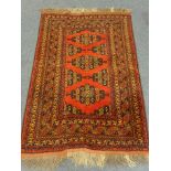Afghan style red ground rug 102cm x 152cm
