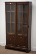 Early 20th century oak bookcase, with two doors enclosing three adjustable shelves,