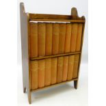 Collection of sixteen volumes of Dickens works, upholstered in red cloth, in oak bookcase, H56cm,