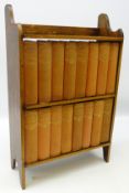 Collection of sixteen volumes of Dickens works, upholstered in red cloth, in oak bookcase, H56cm,