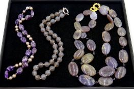 Amethyst and pearl set necklace and two purple/grey stone set necklaces,