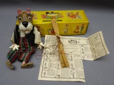 Pelham standard puppet of a Scottie dog in red bat, felt waistcoat and tartan trousers,