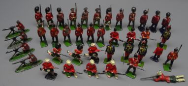 Forty die-cast figures of soldiers by Britains etc including some with articulated arm,