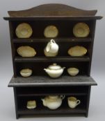 Child's miniature oak Welsh dresser decorated with thirteen pieces of doll's white and gilt