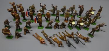 Forty-two die-cast figures of soldiers by Britains etc including drummers, prone with machine guns,