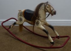 1950s small rocking horse, the dapple painted pressed metal body with horse hair mane and tail,