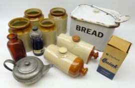 Vintage enamel bread bin and skimmer, stoneware jars and hot water bottles,