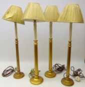 Two pairs of gilded candlestick table lamps with pleated shades,