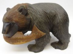 Black Forest style carved model of a bear with salmon catch,
