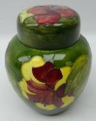 Moorcroft Hibiscus pattern ginger jar and cover on green ground, green signature and original label,