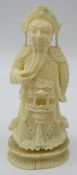 Carved walrus ivory model of an Emperor on oval base, H9.