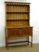 Early 20th century oak dresser, twin shelf back above two cupboard doors, on turned supports,