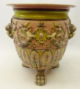 Large Victorian style jardiniere moulded with winged cherubs amongst foliage with two lion mask