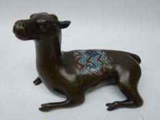 Bronze model of a recumbent hoofed animal with Champleve type saddle,