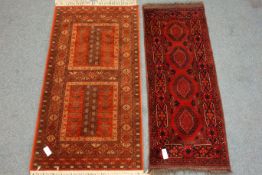 Two Persian style red ground rugs,