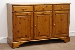 Ducal pine dresser, two glazed doors with central shelves, above three drawers and three cupboards,