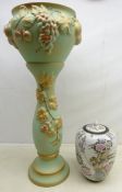 Ceramic jardiniere on stand with fruit moulded decoration,