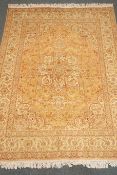 Fine Tabriz (300npsi) beige ground rug, central medallion with repeating border,