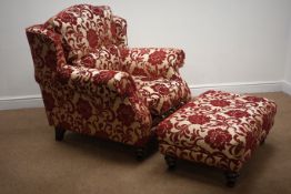 Grande traditional style armchair upholstered in a red and gold embossed fabric with complimentary