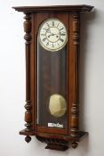 Victorian walnut Vienna style wall clock, Roman dial with twin train movement and brass pendulum,