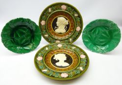 Pair Austrian Schutz Blansko majolica chargers decorated in relief with classical maidens within a