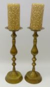 Pair tall brass altar candlesticks with baluster and knop stem on circular base,
