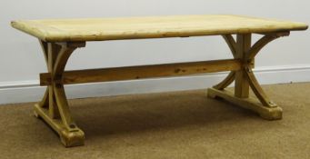 Light wood planked top coffee table, shaped supports joined by single stretcher on sledge feet,