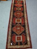 Azerbaijan red and black ground rug, geometric pattern,