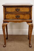 Early 20th century cross banded two drawer walnut lamp table, shell carved cabriole legs, pad feet,