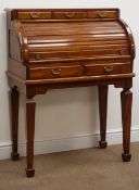 Polished hardwood tambour top desk, fitted drawers with brass handles,