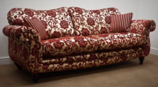 Two Grande sofas upholstered in embossed a red and gold fabric with complimentary scatter cushions