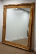 Large rectangular bevelled edge wall mirror in ornate swept gilt frame,