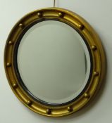 Regency style gilt framed convex wall mirror with ball surround and reeded ebonised,