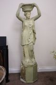 Large composite garden statue of a Roman goddess, standing supporting a flower basket,