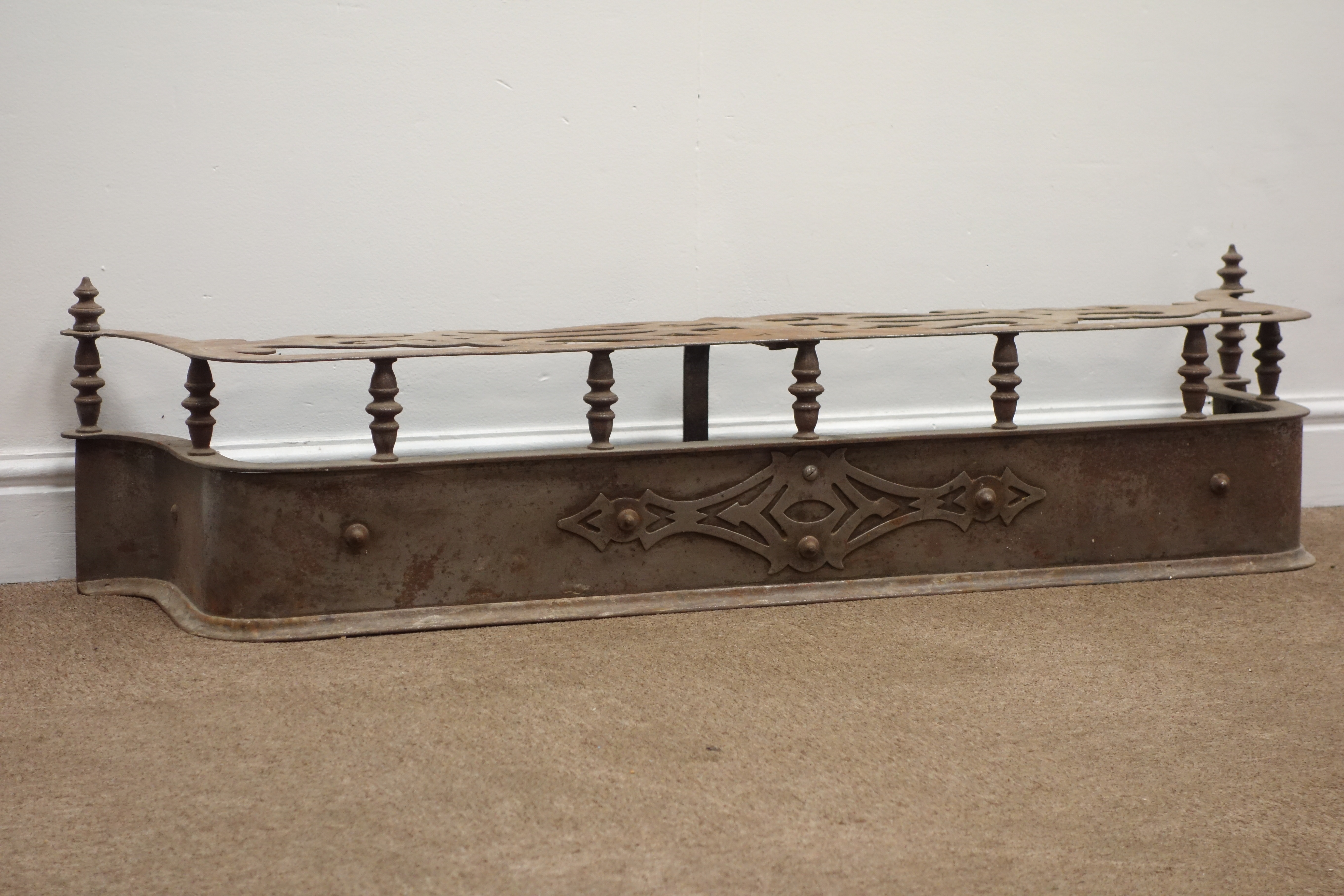Victorian D shaped steel fire fender, shaped and pierced top with two finials, W121cm, H29cm,