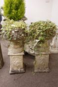 Pair ornate composite campana shaped stone urns,